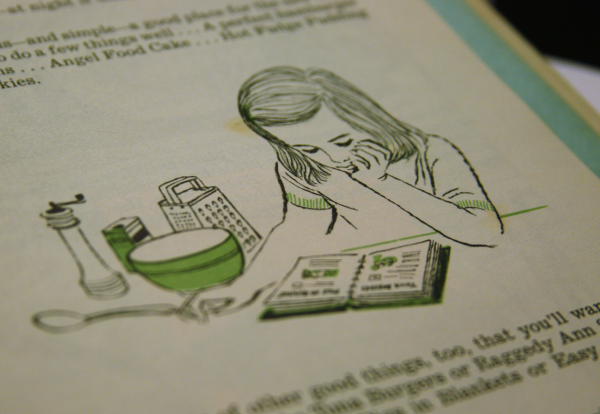 girl reading Betty Crocker Cook Book